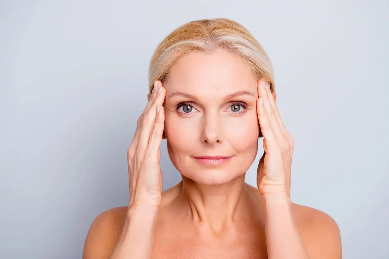 A woman with her hands on her head