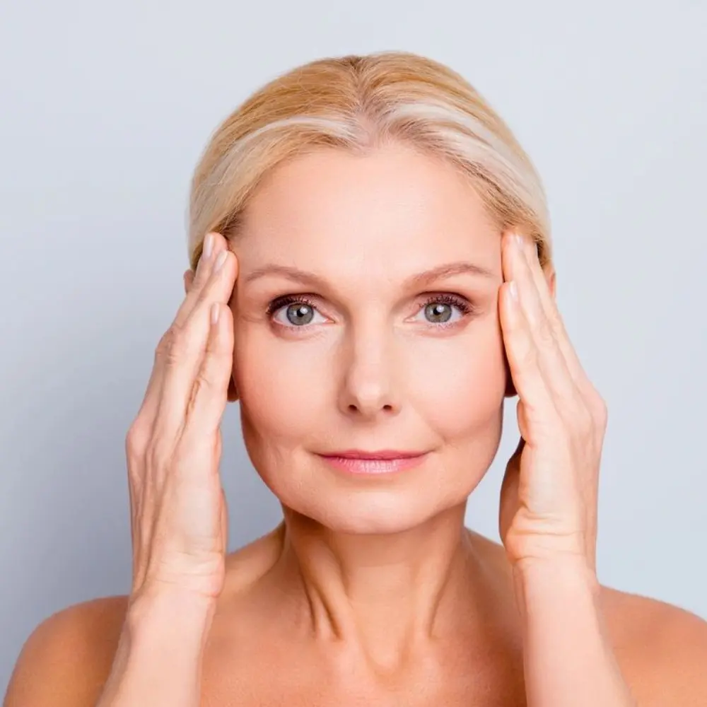 A woman with her hands on her head