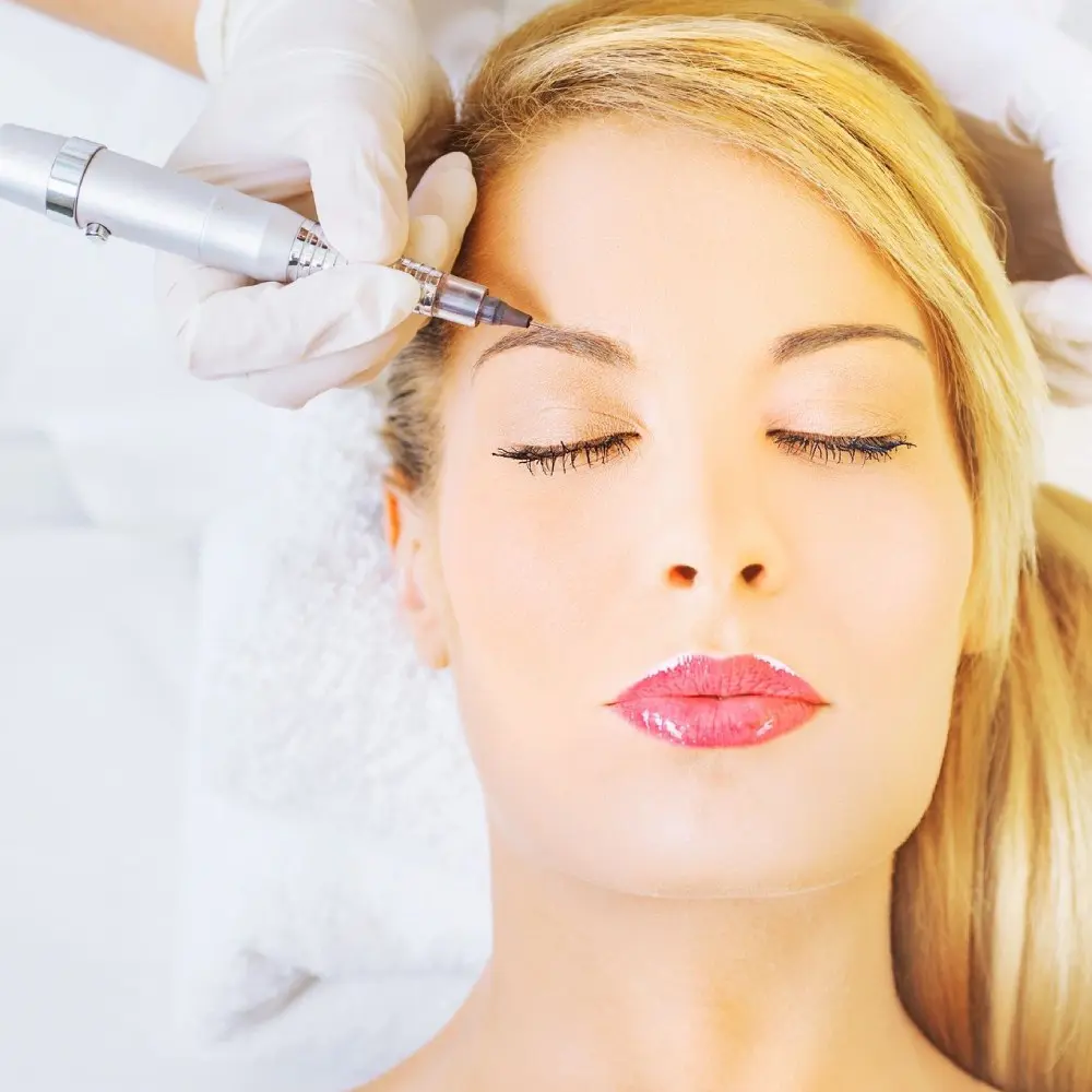 A woman getting her eyebrows threaded at the spa